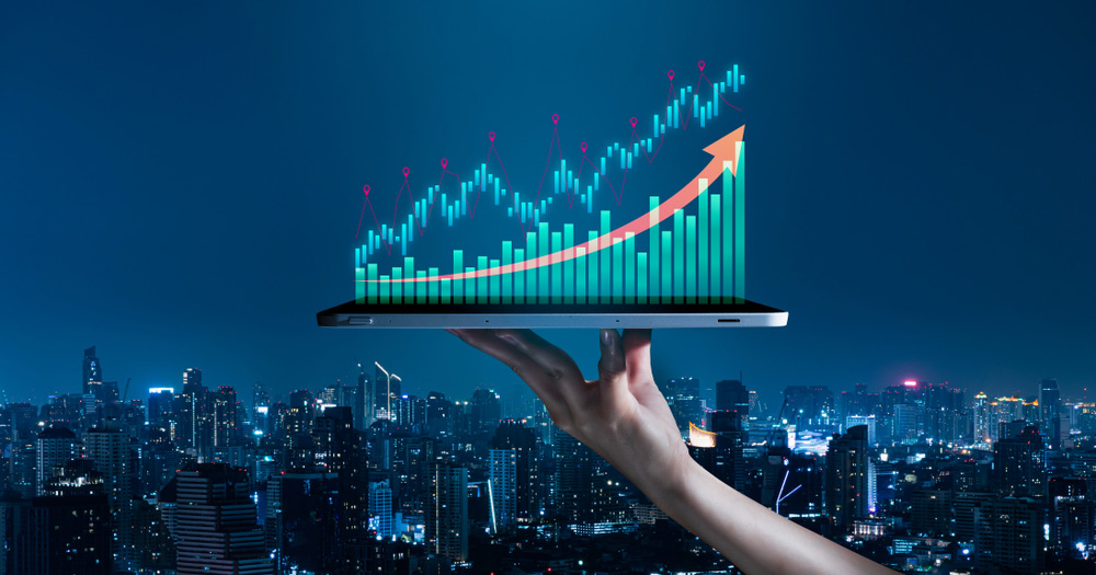 BusinessEvolutionToSuccessAndGrowingGrowthConcepthandHoldingAn Business evolution to success and growing growth concept.hand holding an empty digital tablet with growth stock graph and rising arrow,Corporate representing business growth on cityscape background.