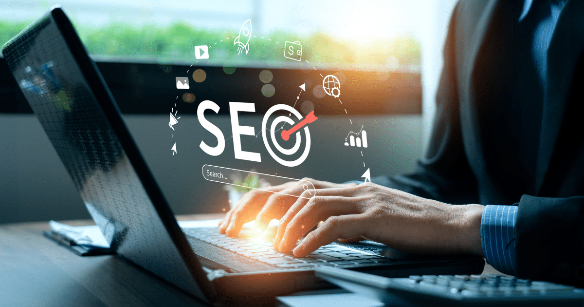 Person working on laptop with SEO analytics icons and digital marketing elements representing SEO in 2026 trends